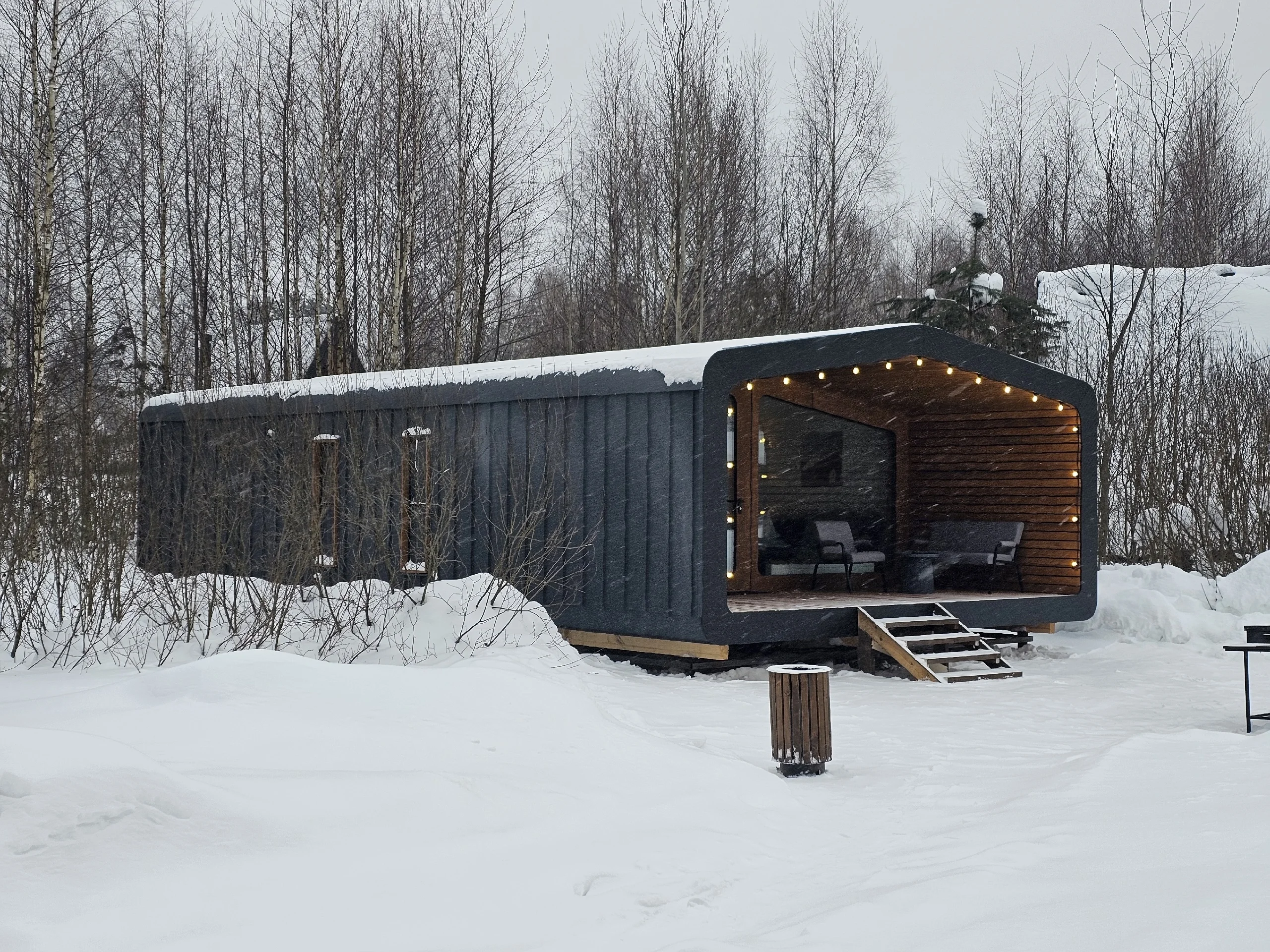 Built BARN 57 cabin with covered veranda in a winter landscape