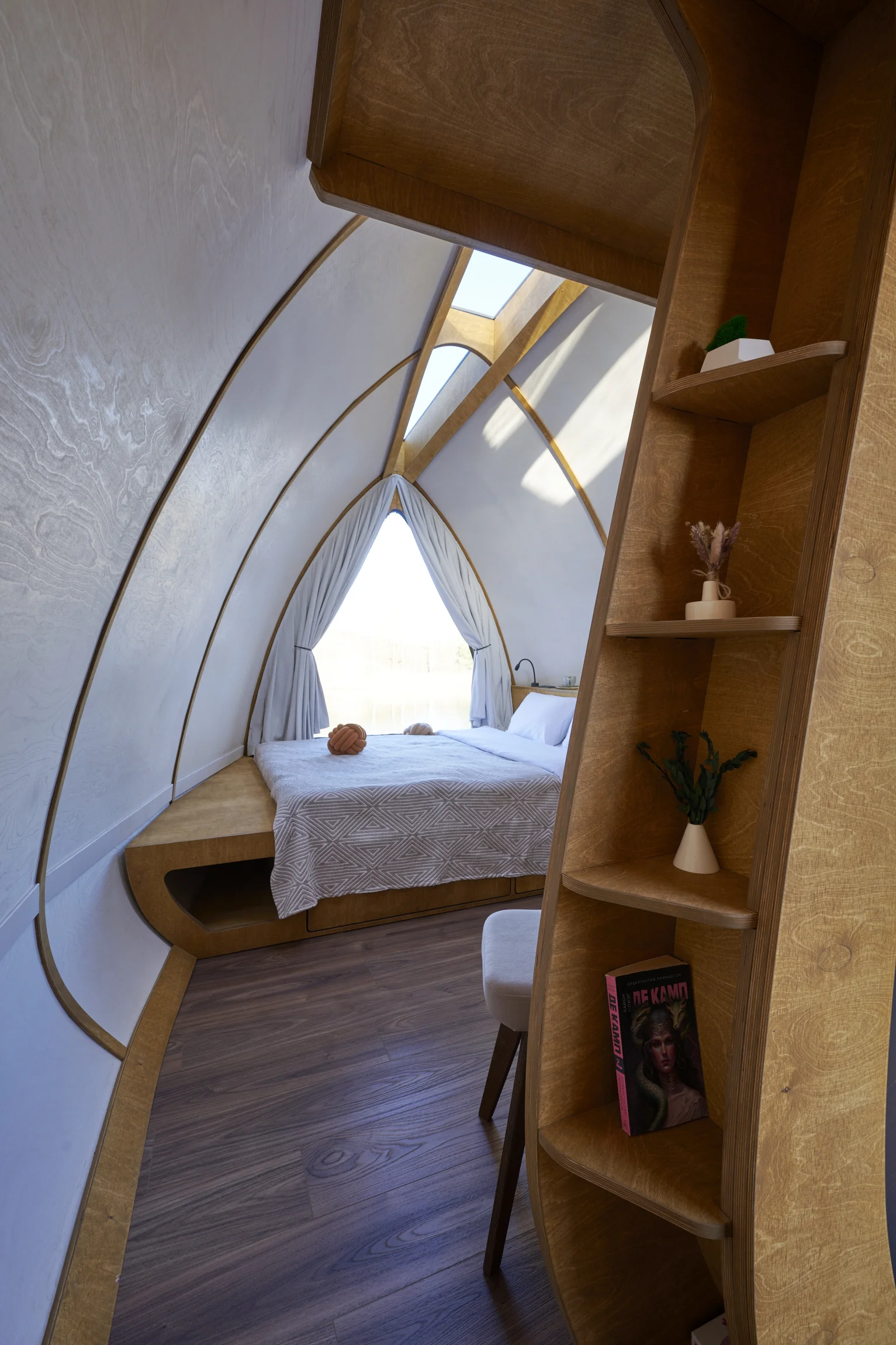HIZ bedroom beneath the curved roof and skylight
