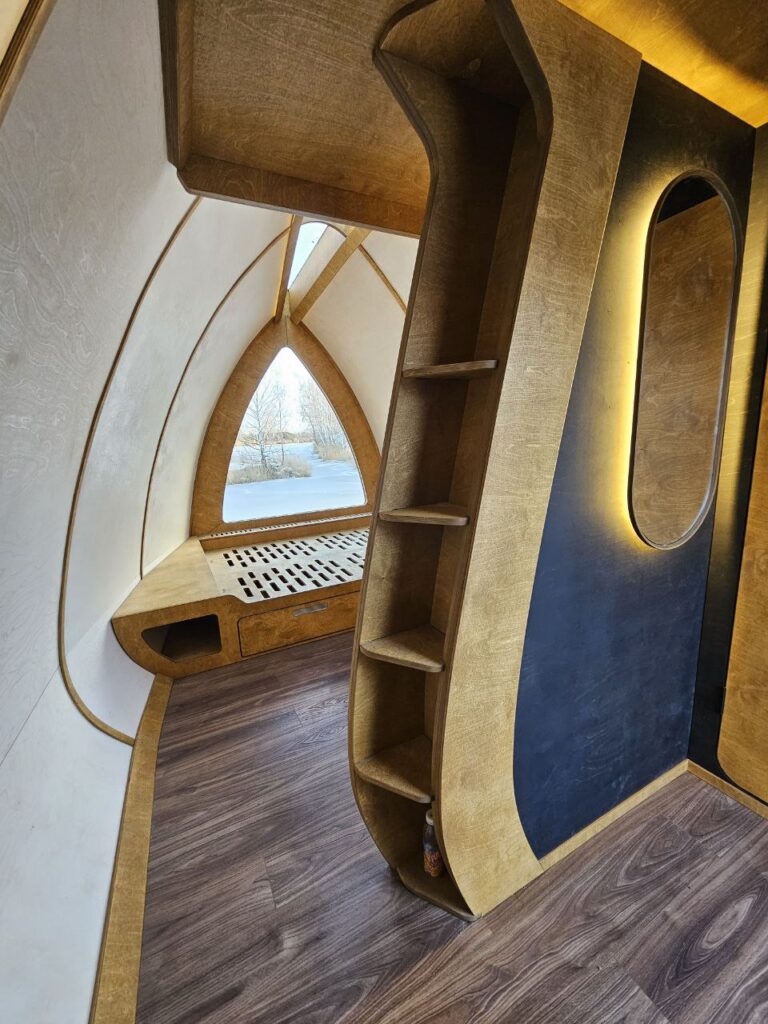 HIZ interior with built-in shelving and an arched window