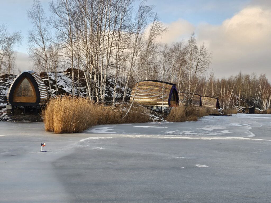 Several built HIZ cabins beside a frozen lake