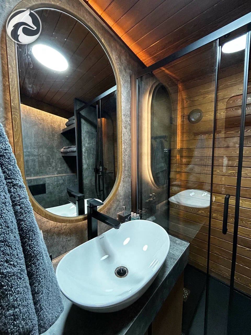 BARN 57 bathroom with shower, sink and illuminated mirror